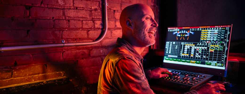 Image of middle-aged man using his computer in a sound studio